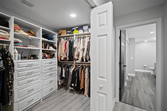 walk in closet featuring visible vents and light wood finished floors