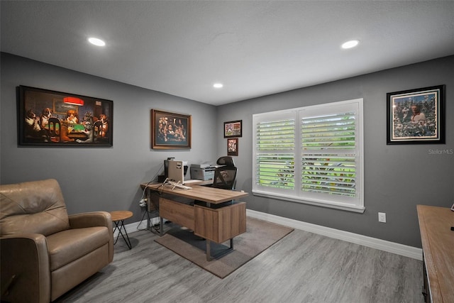 office space with recessed lighting, light wood-type flooring, and baseboards