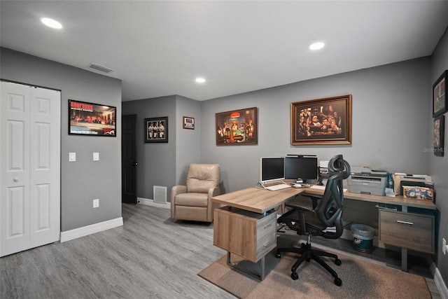 office space featuring recessed lighting, wood finished floors, visible vents, and baseboards