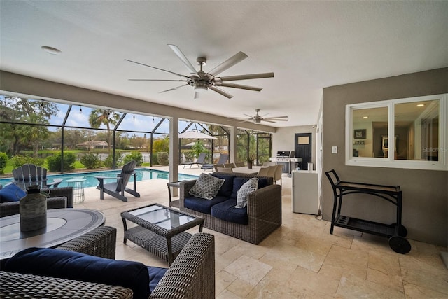 view of patio / terrace featuring grilling area, glass enclosure, an outdoor hangout area, an outdoor pool, and a ceiling fan