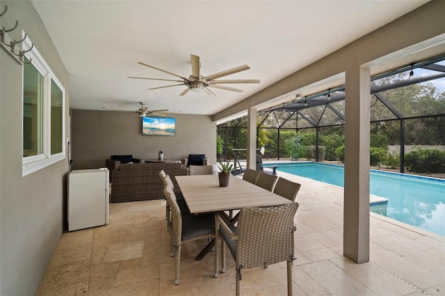 outdoor pool with a lanai, an outdoor living space, ceiling fan, and a patio area