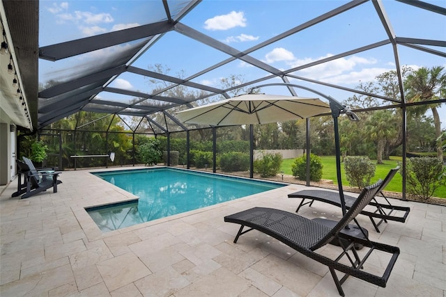 pool with glass enclosure, a patio, and a lawn