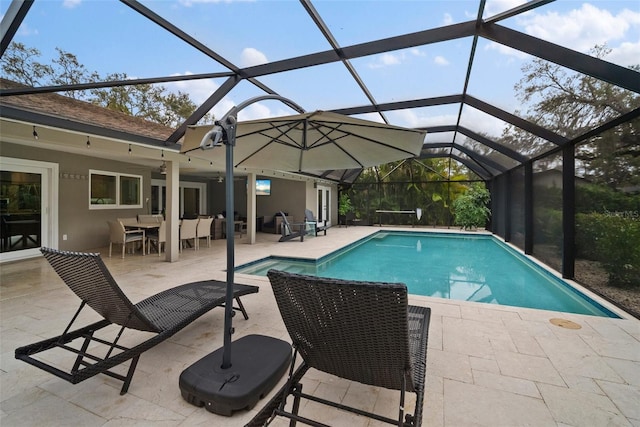 outdoor pool with a lanai and a patio area