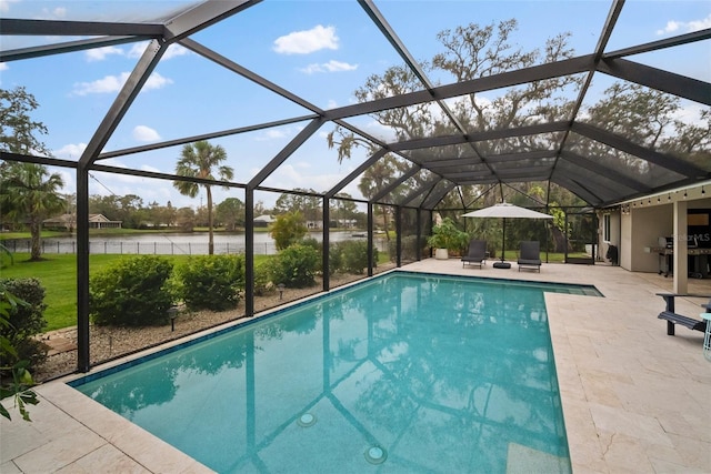 outdoor pool featuring glass enclosure and a patio