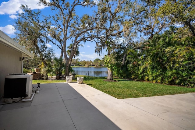 view of patio with cooling unit and a water view