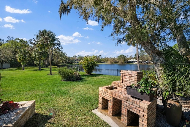 view of yard with fence and a water view