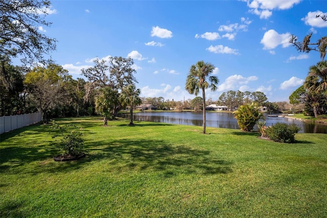 view of yard with fence and a water view