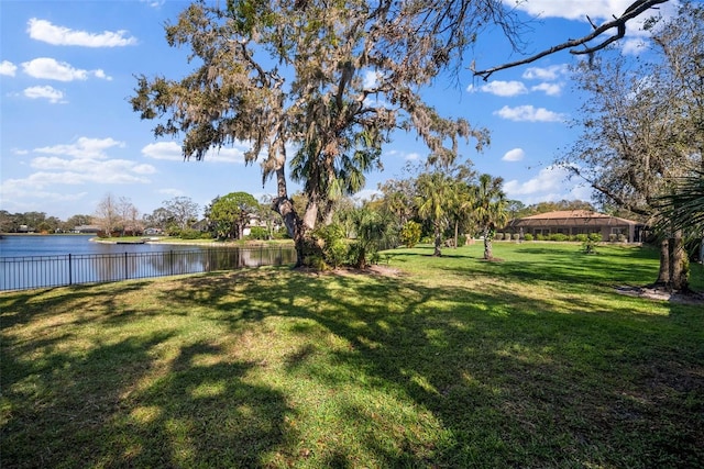 view of yard with fence and a water view