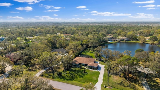 bird's eye view featuring a wooded view and a water view