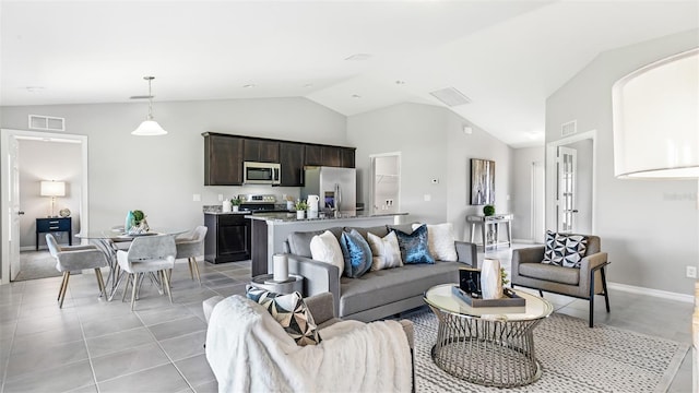 living room featuring visible vents, vaulted ceiling, baseboards, and light tile patterned floors