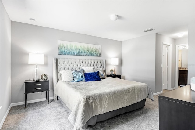 bedroom featuring baseboards, visible vents, and light colored carpet