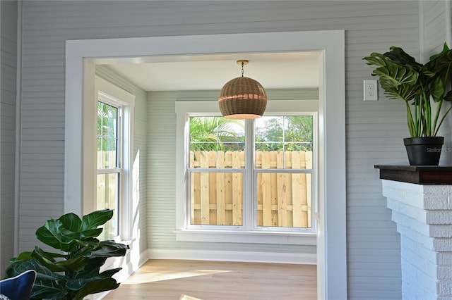 entryway with wood finished floors and baseboards