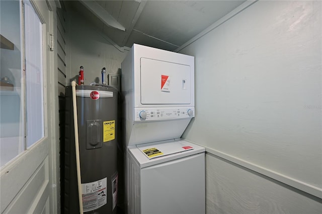 laundry area featuring electric water heater, laundry area, and stacked washer and clothes dryer