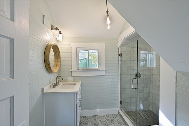 bathroom featuring lofted ceiling, a stall shower, tile patterned floors, and vanity