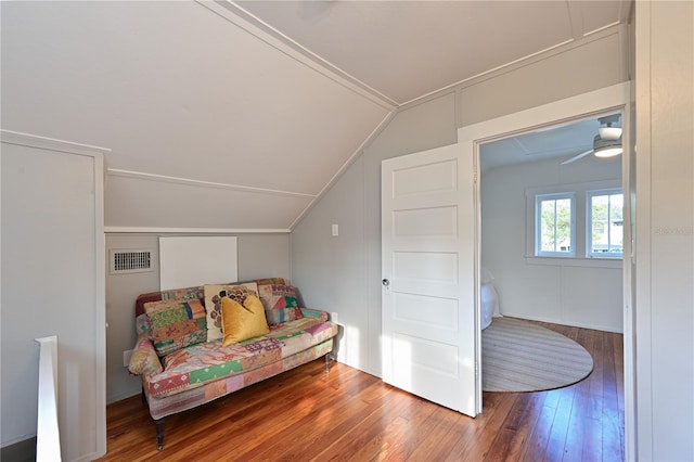 living area featuring vaulted ceiling, hardwood / wood-style floors, and visible vents