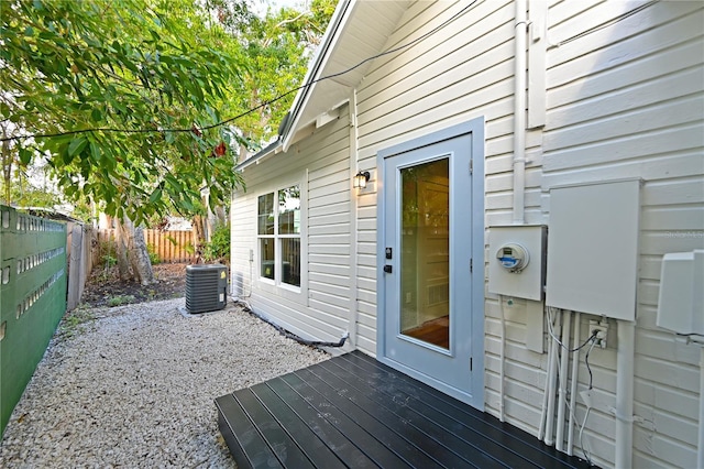 wooden deck with a fenced backyard and cooling unit