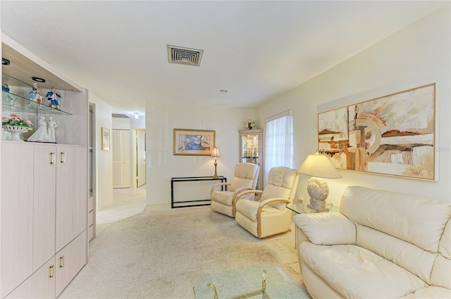 carpeted living room featuring visible vents