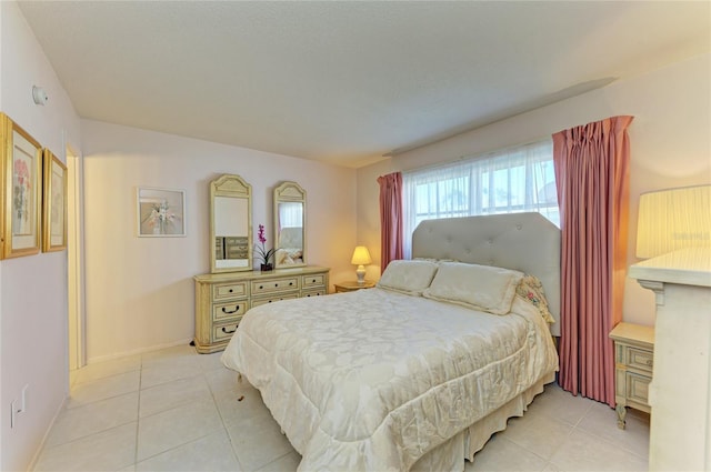 bedroom featuring baseboards and light tile patterned flooring