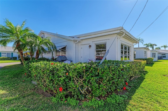 view of property exterior with a yard