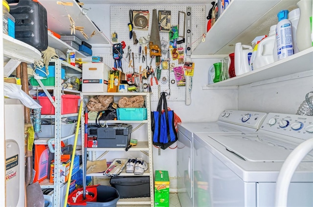 laundry room featuring laundry area, separate washer and dryer, and a workshop area