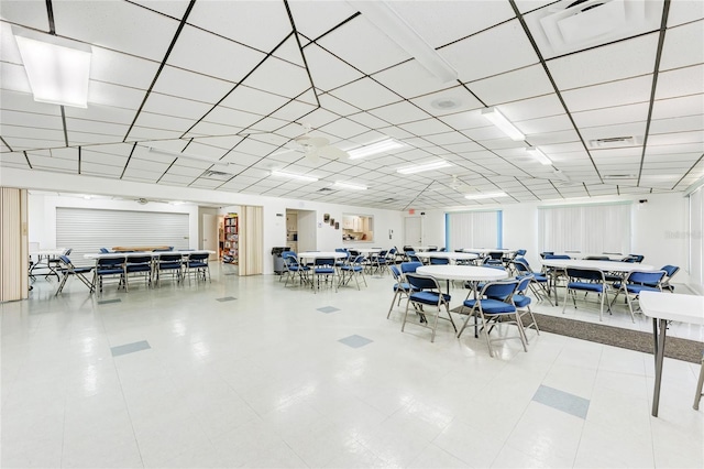 dining area with a paneled ceiling and visible vents