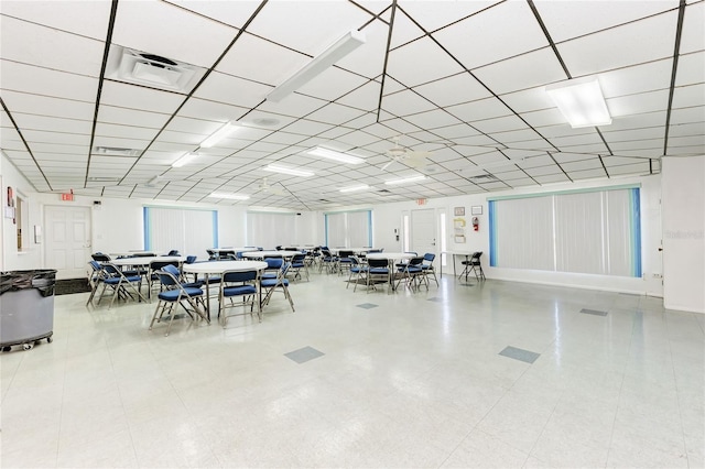 dining space featuring visible vents and a drop ceiling