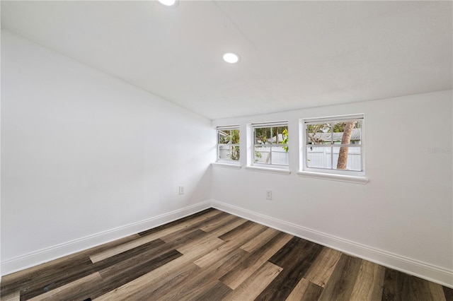 spare room with recessed lighting, dark wood-style flooring, and baseboards