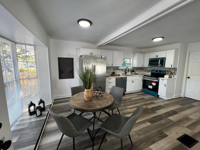 1397 43rd St, Sarasota, FL 34234 - kitchen featuring stainless steel appliances, tasteful backsplash, white cabinetry, light countertops, and beam ceiling
