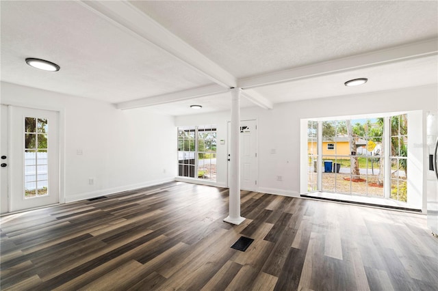 1397 43rd St, Sarasota, FL 34234 - unfurnished living room with dark wood finished floors, plenty of natural light, beamed ceiling, and ornate columns