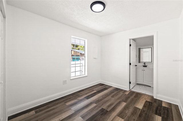 1397 43rd St, Sarasota, FL 34234 - unfurnished room with dark wood-type flooring and a textured ceiling