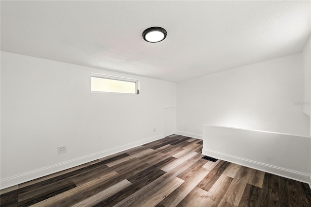 1397 43rd St, Sarasota, FL 34234 - spare room with dark wood-type flooring and baseboards