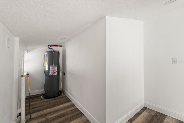 1397 43rd St, Sarasota, FL 34234 - hall featuring water heater, dark wood-style floors, and a textured ceiling
