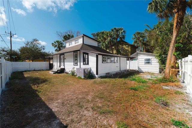 1397 43rd St, Sarasota, FL 34234 - rear view of house featuring a fenced backyard, entry steps, and an outdoor structure