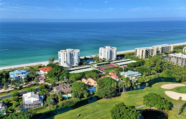 drone / aerial view featuring a water view, golf course view, and a city view