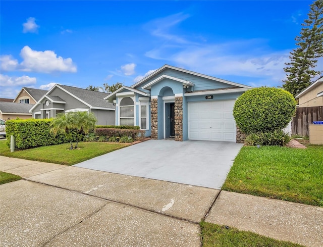 view of front of house with a front yard, fence, a garage, stone siding, and driveway