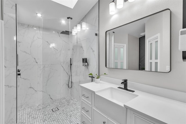 full bath featuring a skylight, a marble finish shower, vanity, and recessed lighting