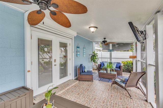 sunroom with ceiling fan and french doors