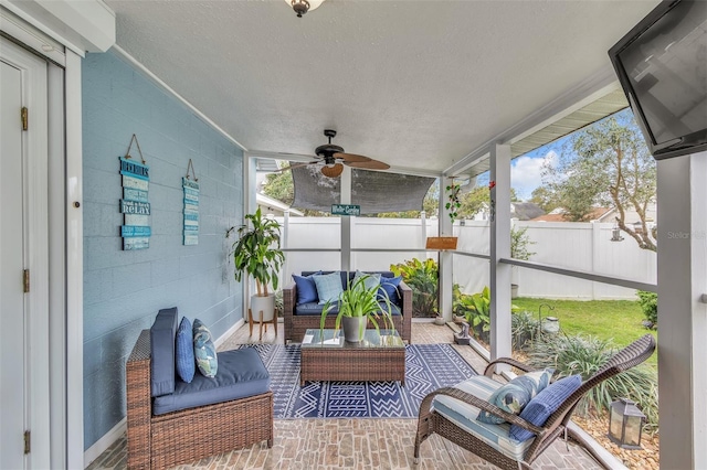 sunroom featuring ceiling fan