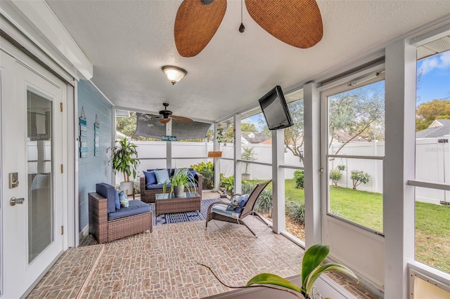 sunroom with a ceiling fan