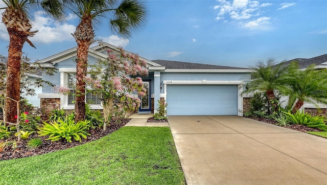 view of front of property with concrete driveway, a front lawn, an attached garage, and stucco siding