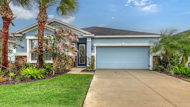 view of front facade featuring stucco siding, a garage, stone siding, driveway, and a front lawn