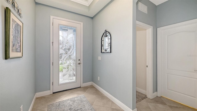 foyer with light tile patterned floors and baseboards