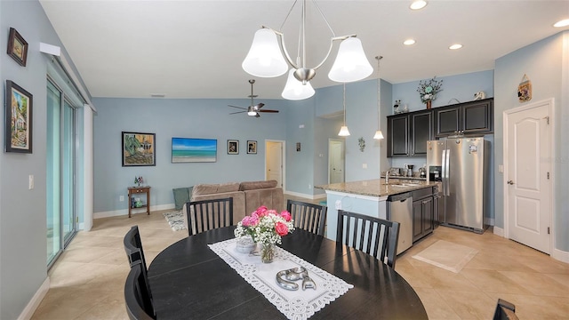 dining room featuring ceiling fan, light tile patterned flooring, lofted ceiling, and baseboards