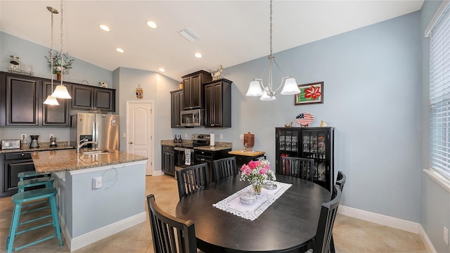 dining space with baseboards, visible vents, lofted ceiling, an inviting chandelier, and recessed lighting