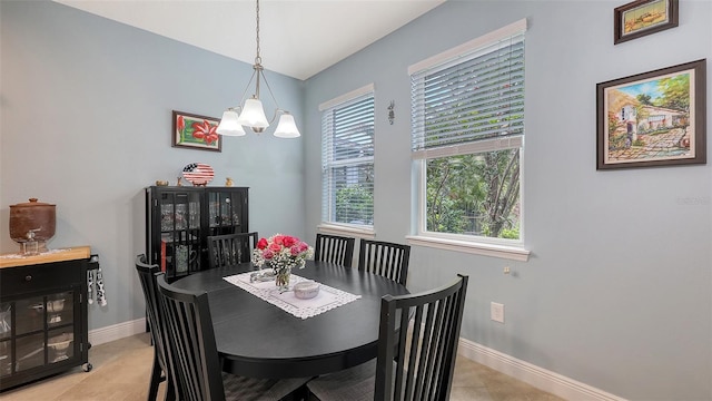 dining space with light tile patterned floors, baseboards, and an inviting chandelier