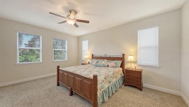 bedroom featuring light carpet, ceiling fan, and baseboards