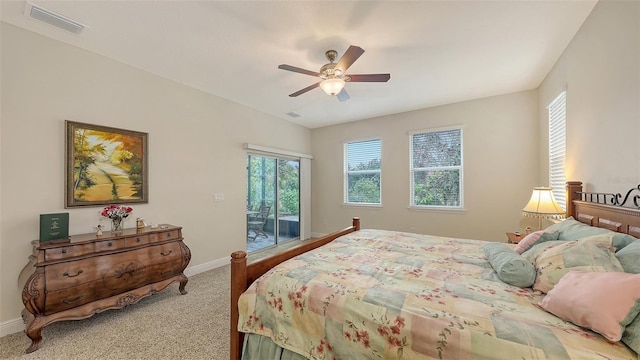 carpeted bedroom with access to exterior, baseboards, visible vents, and ceiling fan