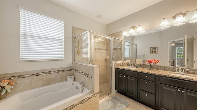 bathroom with double vanity, a stall shower, a sink, and a bath