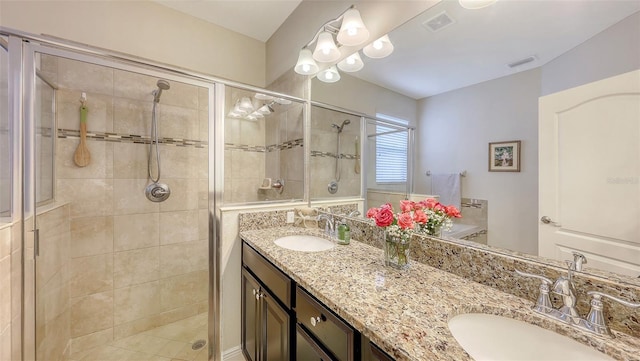 bathroom featuring a stall shower and a sink