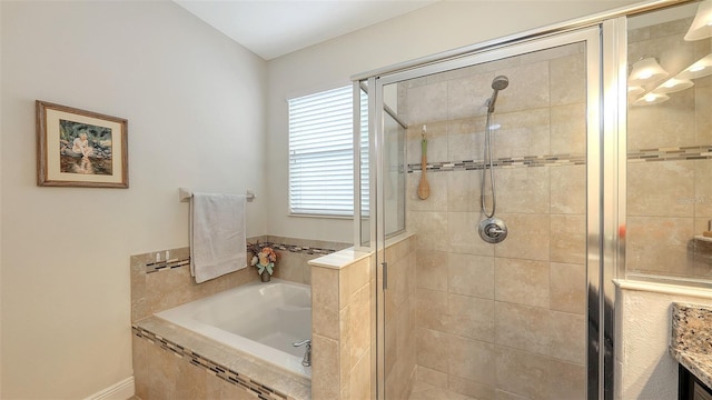 bathroom with a garden tub, vanity, and a shower stall